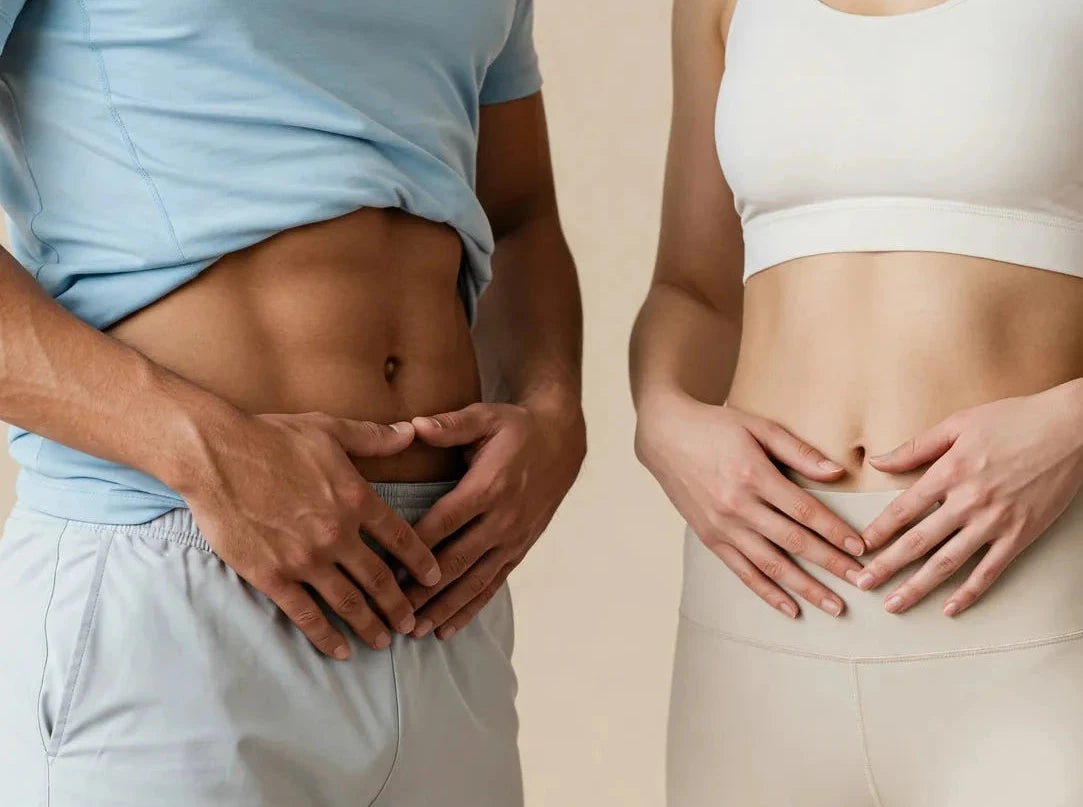 Two people showing their stomachs against a beige background